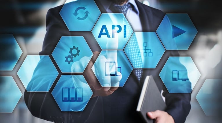 A man pointing at 3D icons of hexagon naming API ,Play button, computer, tablet, etc.