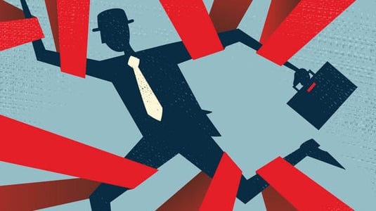 The image depicts a man with briefcase who is trapped in challenges like new sanctions compliance challenge from all angles.